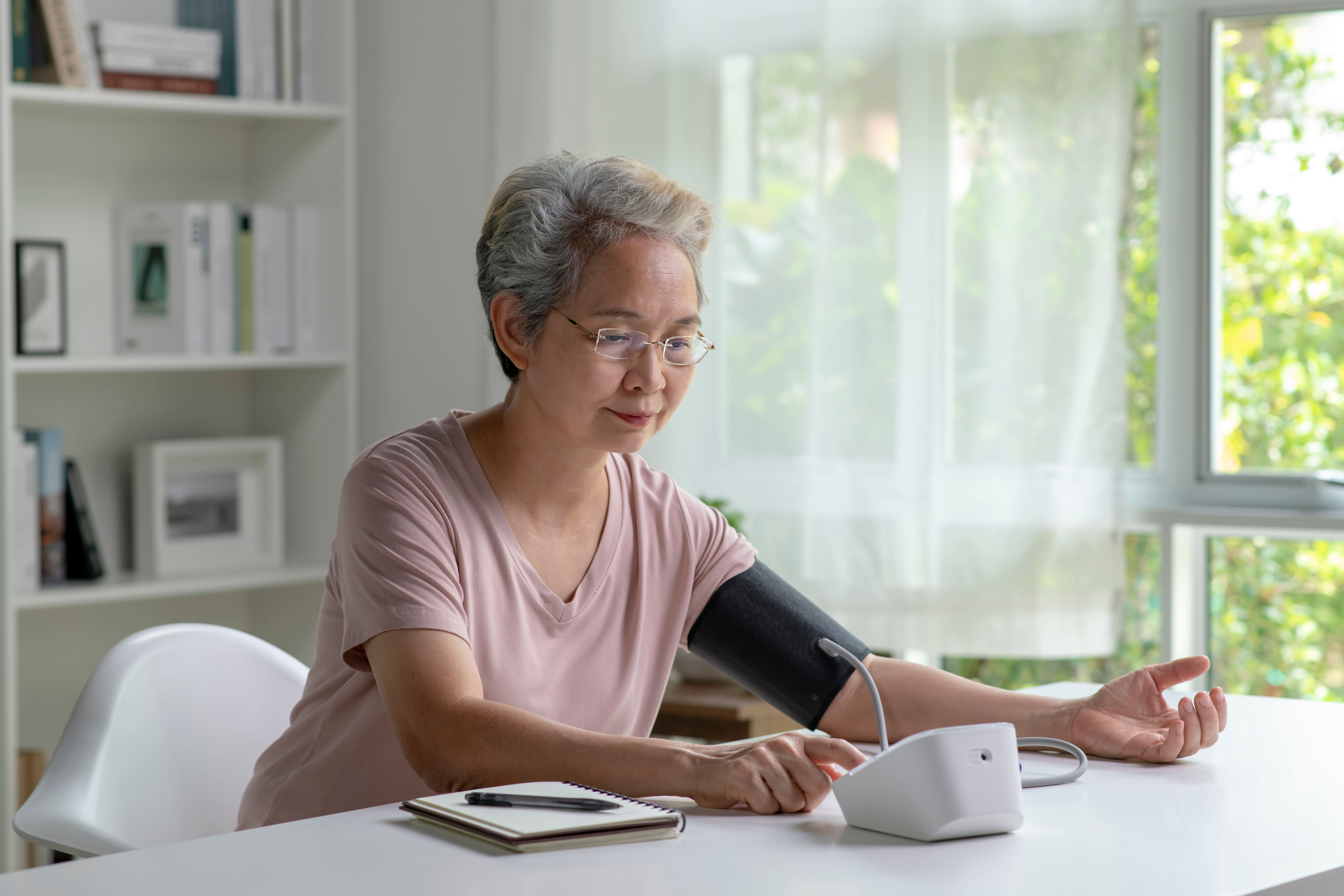 Asian senior woman measuring blood pressure at home Patient checking blood pressure at home